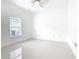 Bright bedroom with large window, ceiling fan, and white tile floors at 759 Largo Pass, Kissimmee, FL 34759