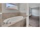 Bathroom with oval bathtub and view to bedroom at 792 Del Prado Dr, Kissimmee, FL 34758