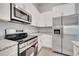 Modern kitchen boasts stainless steel appliances and granite countertops at 792 Del Prado Dr, Kissimmee, FL 34758