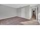 Well-lit bedroom with carpet flooring and door access at 792 Del Prado Dr, Kissimmee, FL 34758