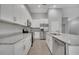 Bright kitchen with white cabinets, granite counters, and stainless steel appliances at 792 Del Prado Dr, Kissimmee, FL 34758