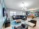 Open concept living room with sectional sofa and view of dining area at 9158 Wedge Dr, Davenport, FL 33896