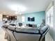 Living room features sectional sofa, large TV, and stylish decor at 9158 Wedge Dr, Davenport, FL 33896