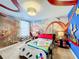 A bedroom with a Mario Kart theme, featuring a custom-designed bed and mural at 9158 Wedge Dr, Davenport, FL 33896