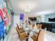 Open concept dining room with glass table and adjacent living space at 9158 Wedge Dr, Davenport, FL 33896