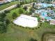 Community sand volleyball court surrounded by lush landscaping at 9158 Wedge Dr, Davenport, FL 33896