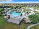 Community pool and relaxing area with thatched roof cabanas at 9158 Wedge Dr, Davenport, FL 33896