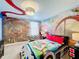 A bedroom with a Mario Kart theme, featuring a custom-designed bed and mural at 9158 Wedge Dr, Davenport, FL 33896
