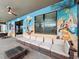Large patio with mural, seating and pool view at 9158 Wedge Dr, Davenport, FL 33896