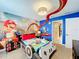 Themed bedroom with Mario Kart mural and a custom video game controller bed at 9158 Wedge Dr, Davenport, FL 33896