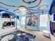 Themed bedroom with bunk beds, featuring a space-themed mural and ceiling design at 9158 Wedge Dr, Davenport, FL 33896