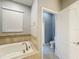 Bathroom with a soaking tub and separate toilet at 9158 Wedge Dr, Davenport, FL 33896