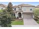 Two-story house with a brick driveway and landscaping at 9158 Wedge Dr, Davenport, FL 33896