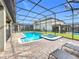 Screened pool and spa with patio and lounge chairs at 9158 Wedge Dr, Davenport, FL 33896