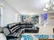 Open concept living area with sectional sofa and view into kitchen at 9158 Wedge Dr, Davenport, FL 33896