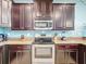 Modern kitchen with stainless steel appliances and granite countertops at 9158 Wedge Dr, Davenport, FL 33896