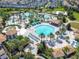Large community pool with surrounding lounge chairs and palm trees at 9158 Wedge Dr, Davenport, FL 33896