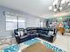 Spacious living room with sectional sofa, large TV, and view of dining area at 9158 Wedge Dr, Davenport, FL 33896