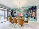 Gathering dining room features a glass table, mural, and seating for eight at 9158 Wedge Dr, Davenport, FL 33896
