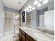 Bathroom boasts double sinks, granite counters, and a shower at 9158 Wedge Dr, Davenport, FL 33896