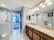 Bathroom with granite double vanity and walk in shower at 9158 Wedge Dr, Davenport, FL 33896
