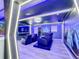 Futuristic home theater with LED lighting, comfy seating, and large screen at 9158 Wedge Dr, Davenport, FL 33896