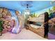 Rustic-themed bedroom with bunk beds and waterfall feature at 9158 Wedge Dr, Davenport, FL 33896