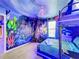 Jungle-themed bedroom with a full-size bed and mural at 9158 Wedge Dr, Davenport, FL 33896