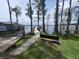 A lakeside walkway leads to a dock with a bench nearby at 98 E 10Th Ave, Windermere, FL 34786