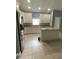 Modern kitchen with white cabinets, granite island, and stainless steel appliances at 1021 Hacienda Cir, Kissimmee, FL 34741