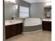 Double vanity bathroom with a large garden tub and tile flooring at 1021 Hacienda Cir, Kissimmee, FL 34741