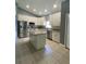 Modern kitchen featuring white cabinets, granite countertops, and stainless steel appliances at 1021 Hacienda Cir, Kissimmee, FL 34741