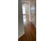 Long hallway with hardwood floors and access to other rooms at 1021 Hacienda Cir, Kissimmee, FL 34741