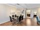 Glass dining table with six chairs in the well-lit dining area at 1301 Tuscan Ter # 9106, Davenport, FL 33896