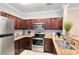 Well-equipped kitchen featuring stainless steel appliances and dark wood cabinets at 1301 Tuscan Ter # 9106, Davenport, FL 33896