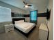 Bedroom with a king-size bed, teal accents, and a wall-mounted TV at 1799 Caribbean View Ter, Kissimmee, FL 34747