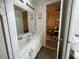 Double vanity bathroom with white cabinets and a view of a bedroom at 1799 Caribbean View Ter, Kissimmee, FL 34747
