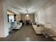 Open living room with neutral colored sofas and a fireplace at 1799 Caribbean View Ter, Kissimmee, FL 34747