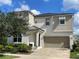 Two-story house with a large driveway and landscaped yard at 1799 Caribbean View Ter, Kissimmee, FL 34747