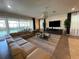 Spacious living area with sectional sofa, large TV, and pool view at 1799 Caribbean View Ter, Kissimmee, FL 34747