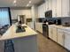 Modern kitchen with white cabinets, stainless steel appliances, and large island at 1799 Caribbean View Ter, Kissimmee, FL 34747