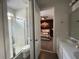 Bathroom with a double vanity, shower, and view of a bedroom at 1799 Caribbean View Ter, Kissimmee, FL 34747