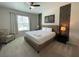 Bedroom with a king-size bed and a world map accent wall at 1799 Caribbean View Ter, Kissimmee, FL 34747