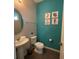 Small bathroom with teal walls and nautical decor at 1799 Caribbean View Ter, Kissimmee, FL 34747