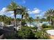 Large community pool with palm trees and lounge chairs at 1799 Caribbean View Ter, Kissimmee, FL 34747