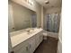Bathroom with single vanity, shower/tub combo, and white cabinets at 1799 Caribbean View Ter, Kissimmee, FL 34747
