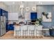 Modern kitchen with blue cabinets, stainless steel appliances, and a large island at 2133 Pine Oak Loop, Davenport, FL 33837