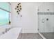 Elegant bathroom with soaking tub, walk-in shower, and modern fixtures at 2133 Pine Oak Loop, Davenport, FL 33837