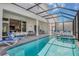 Inviting pool area with lounge chairs and covered patio at 2133 Pine Oak Loop, Davenport, FL 33837