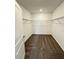 Large walk-in closet with hanging rods and neutral carpeting at 2720 Pierr St, Davenport, FL 33837